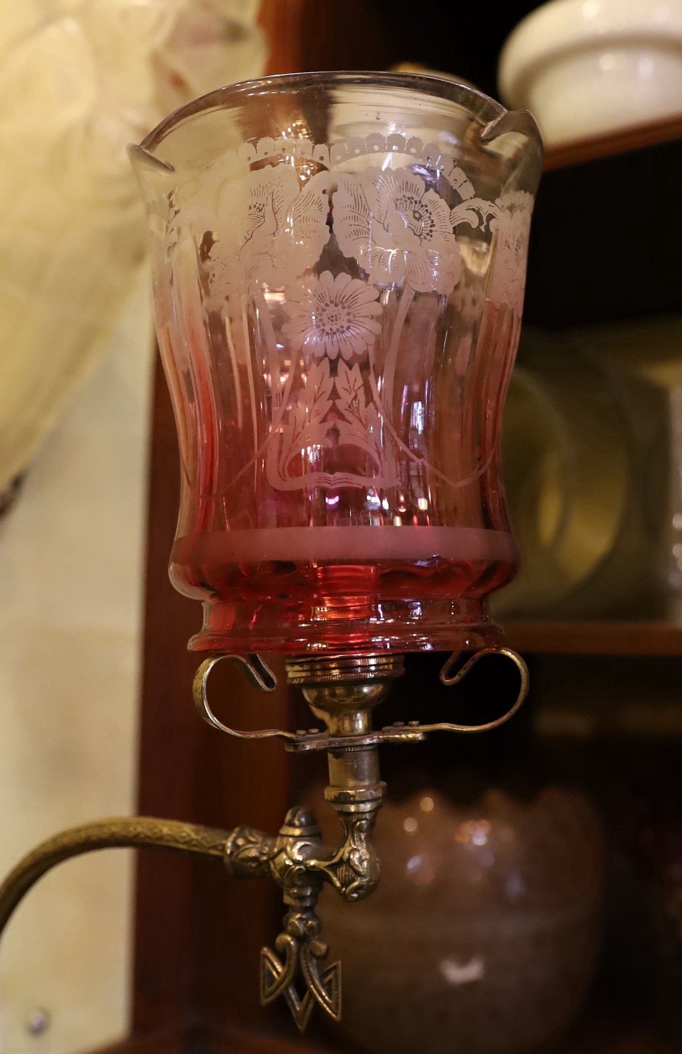 A Victorian brass gasolier wall light with cranberry tinted etched glass shade, now converted to electricity, height 38cm. depth 38cm